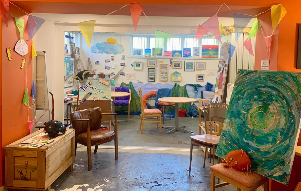 A picture of the Take Me to the Sea exhibition at October Books community room during April 2023.